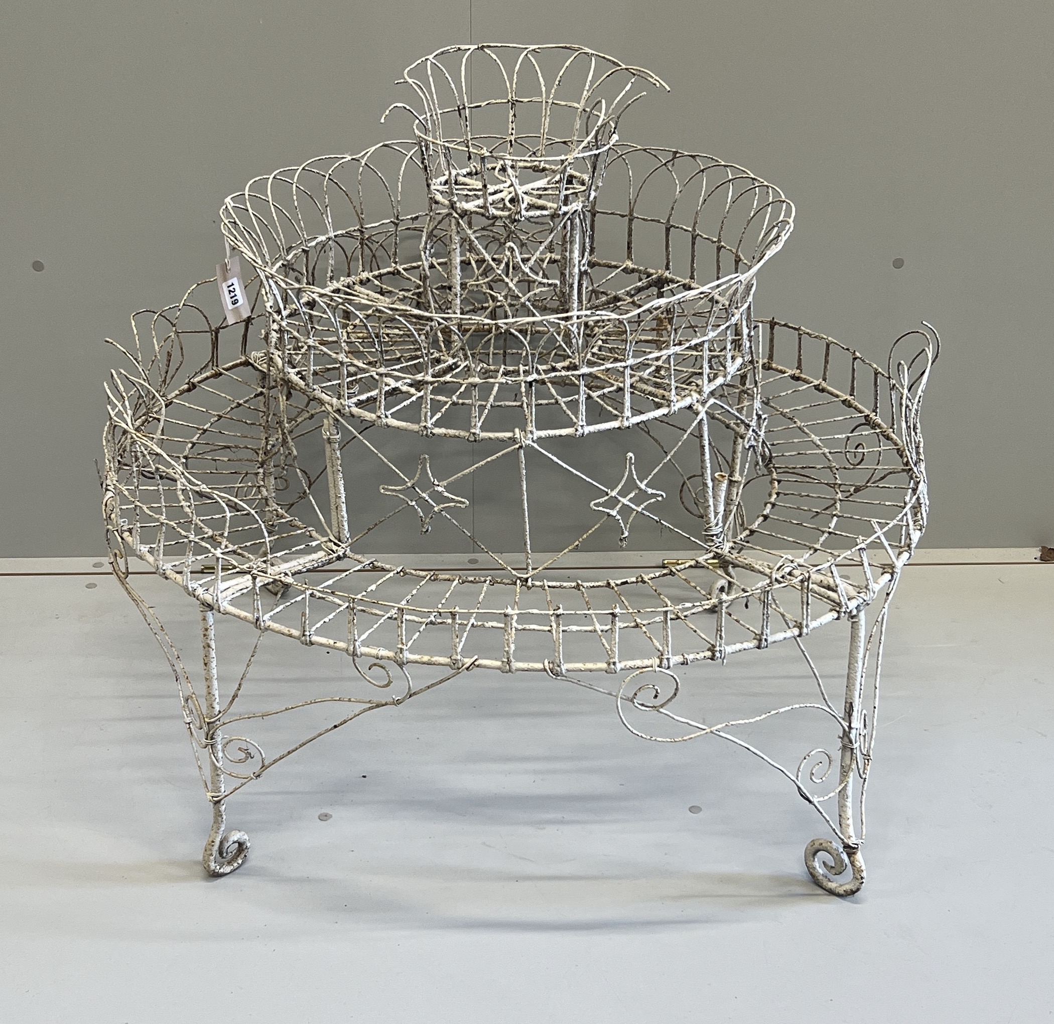 A Victorian painted wirework circular three tier pot stand, diameter 94cm, height 81cm